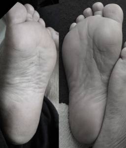 greek nurse rests soles on dead and tied mandalorian's balls . Barefoof nurse without mercy .