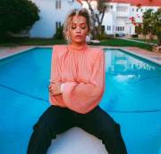 Rita Ora Breasts in See Through Pink Blouse